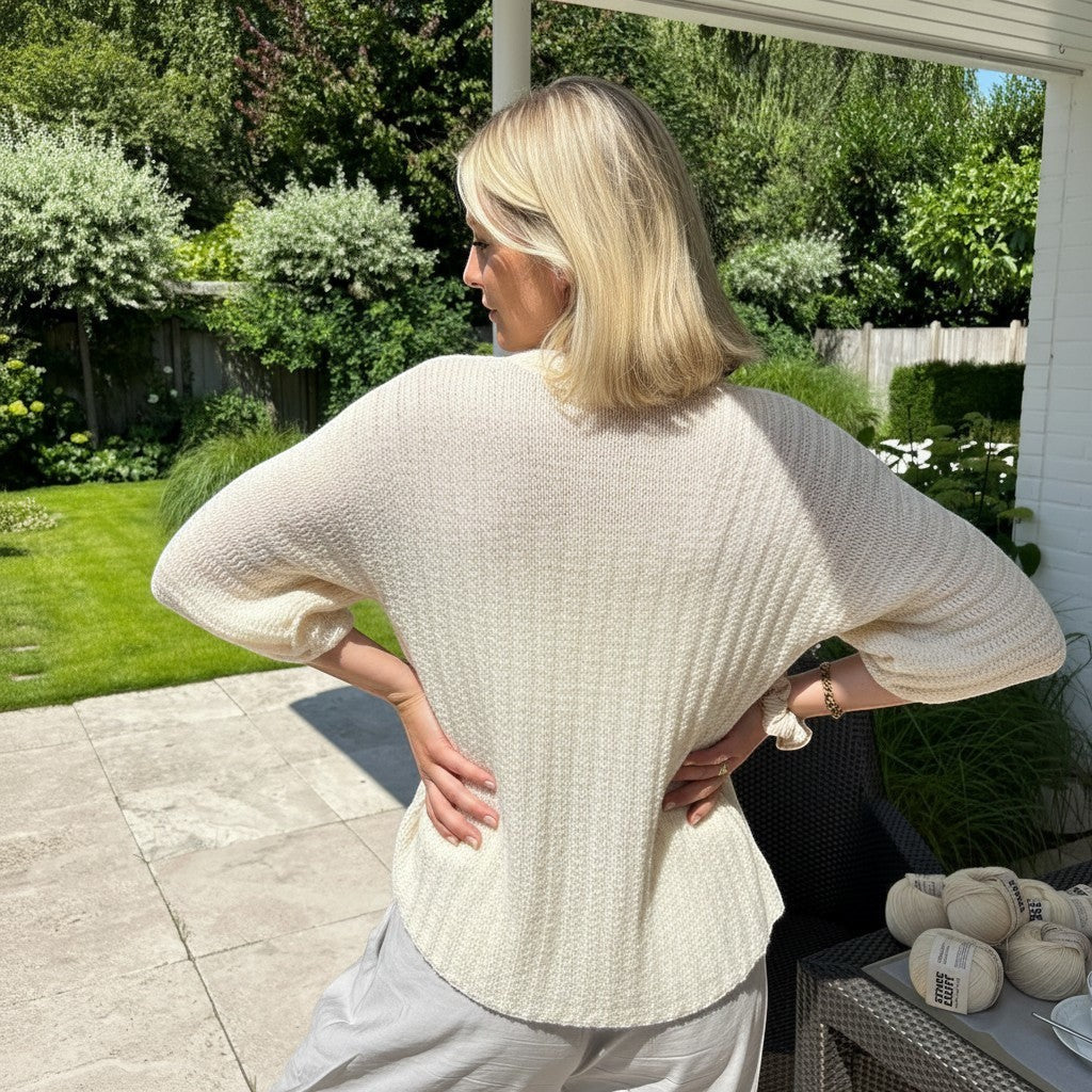 BellaLana Häkel-Set für einen cremeweißen Bambus-Cardigan mit Kimono-Ärmeln, getragen von einer Frau im Garten.
